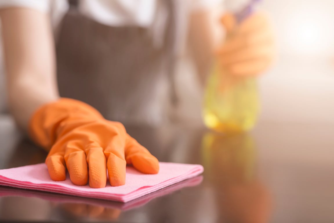 Residential Cleaning Service. Closeup Of Housemaid's Hand Cleans Dust From Table